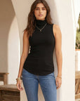 Sleeveless turtleneck top in brushed rib fabric with curved shirttail hem and comfortable stretch