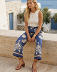 Tilly Cropped Pants with floral vine border print, high-rise wide-leg silhouette, and elastic waistband