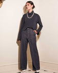 Woman wearing Miles wide-leg trouser in indigo twill with contrast stitching and a black long-sleeve top.