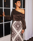 Woman wearing Mia Bias Skirt with intricate scarf-inspired block print satin and elastic waistband