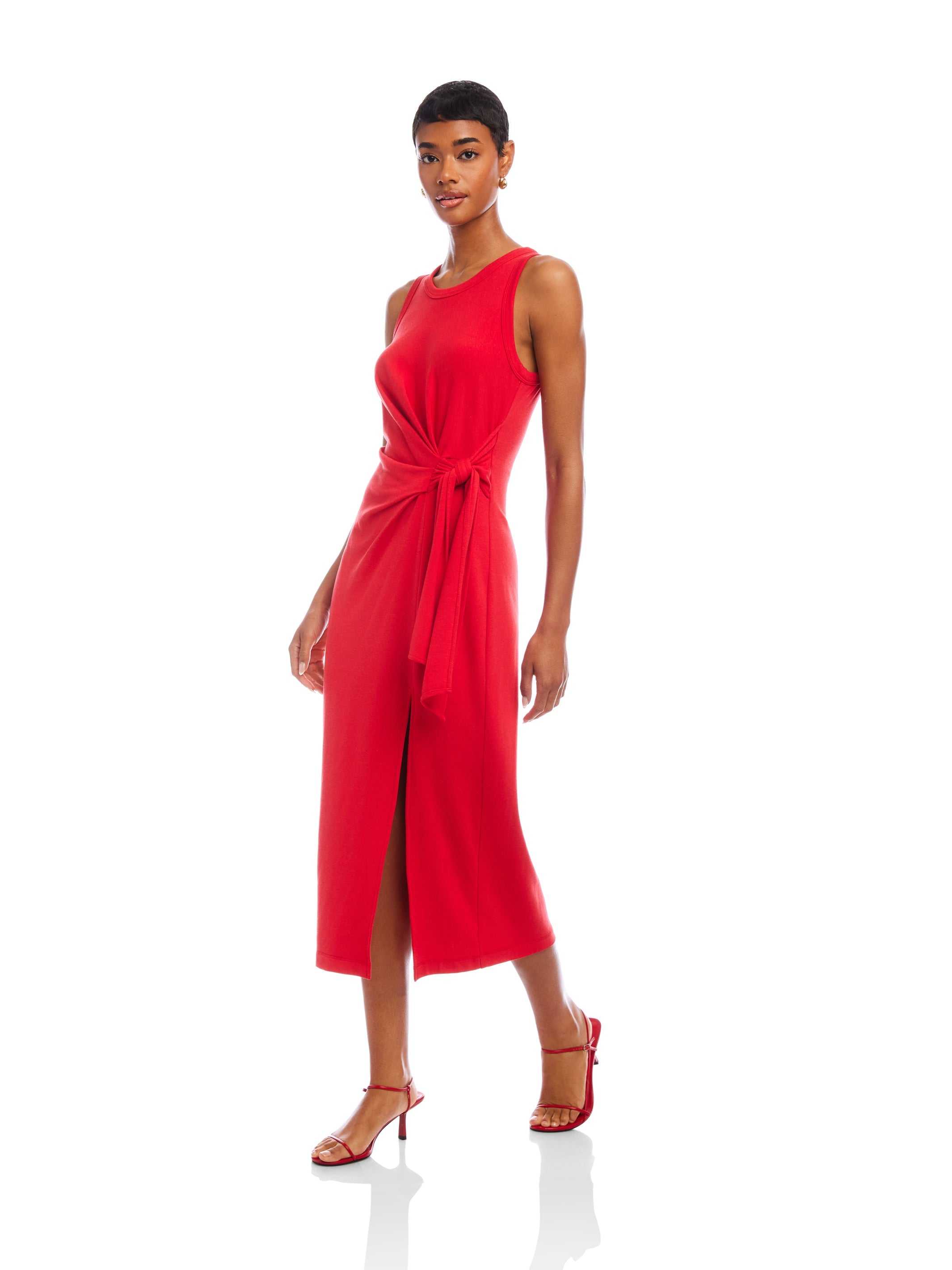 Woman wearing a red Maddie Side-Knot Midi Dress with side slit and sleeveless design