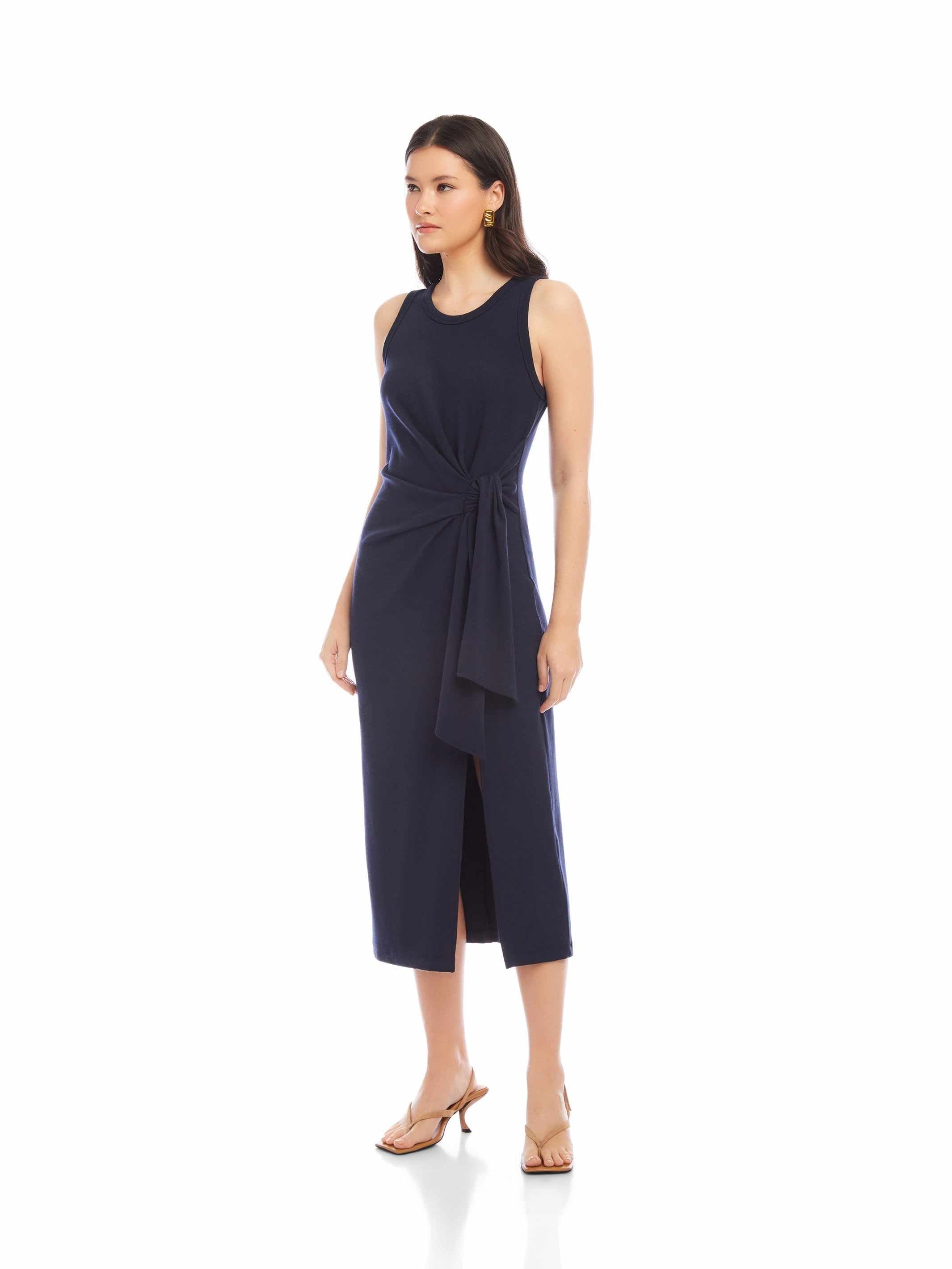 Woman wearing sleeveless navy Maddie Side-Knot Midi Dress with side slit and fitted design