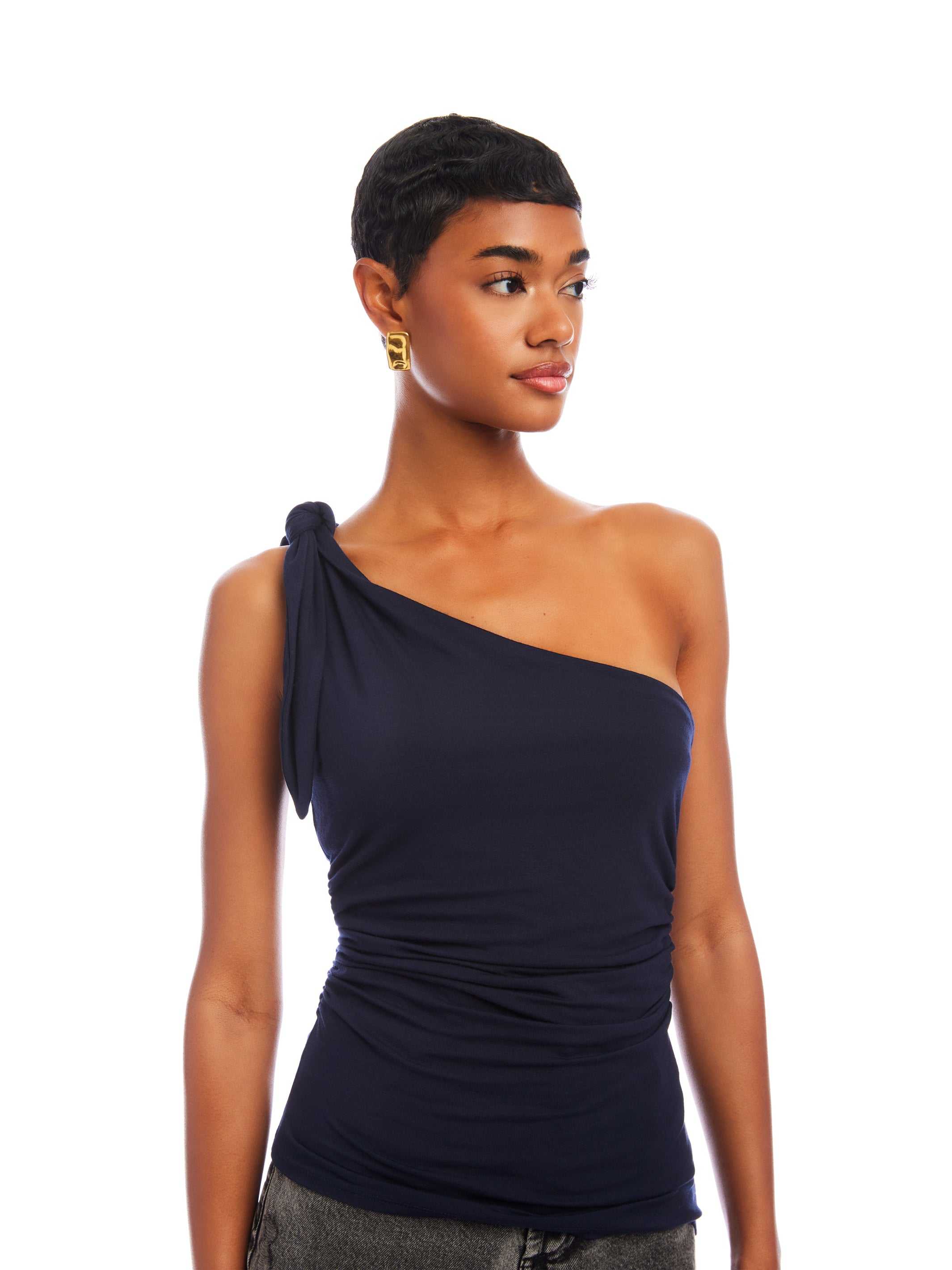 Woman wearing navy Harper One-Shoulder Tie-Top with asymmetrical silhouette and shoulder tie detail