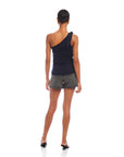 Woman wearing navy Harper One-Shoulder Tie-Top with sleeveless asymmetrical silhouette and tie detail on shoulder paired with gray shorts