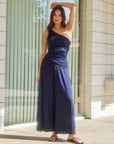 woman wearing navy Shilo wide-leg ankle pants and matching one-shoulder top standing outdoors