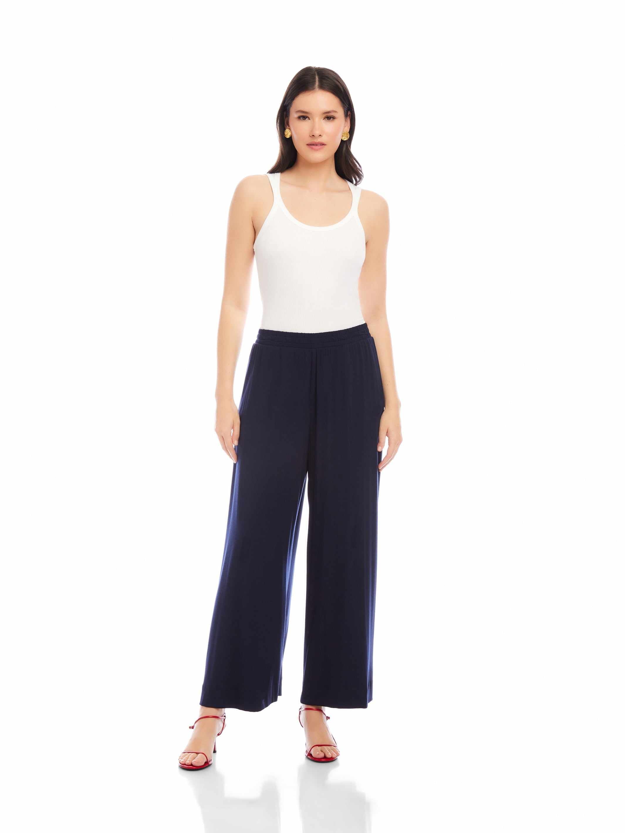 Woman wearing navy Shilo Wide-Leg Ankle Pants with elastic waistband and white tank top