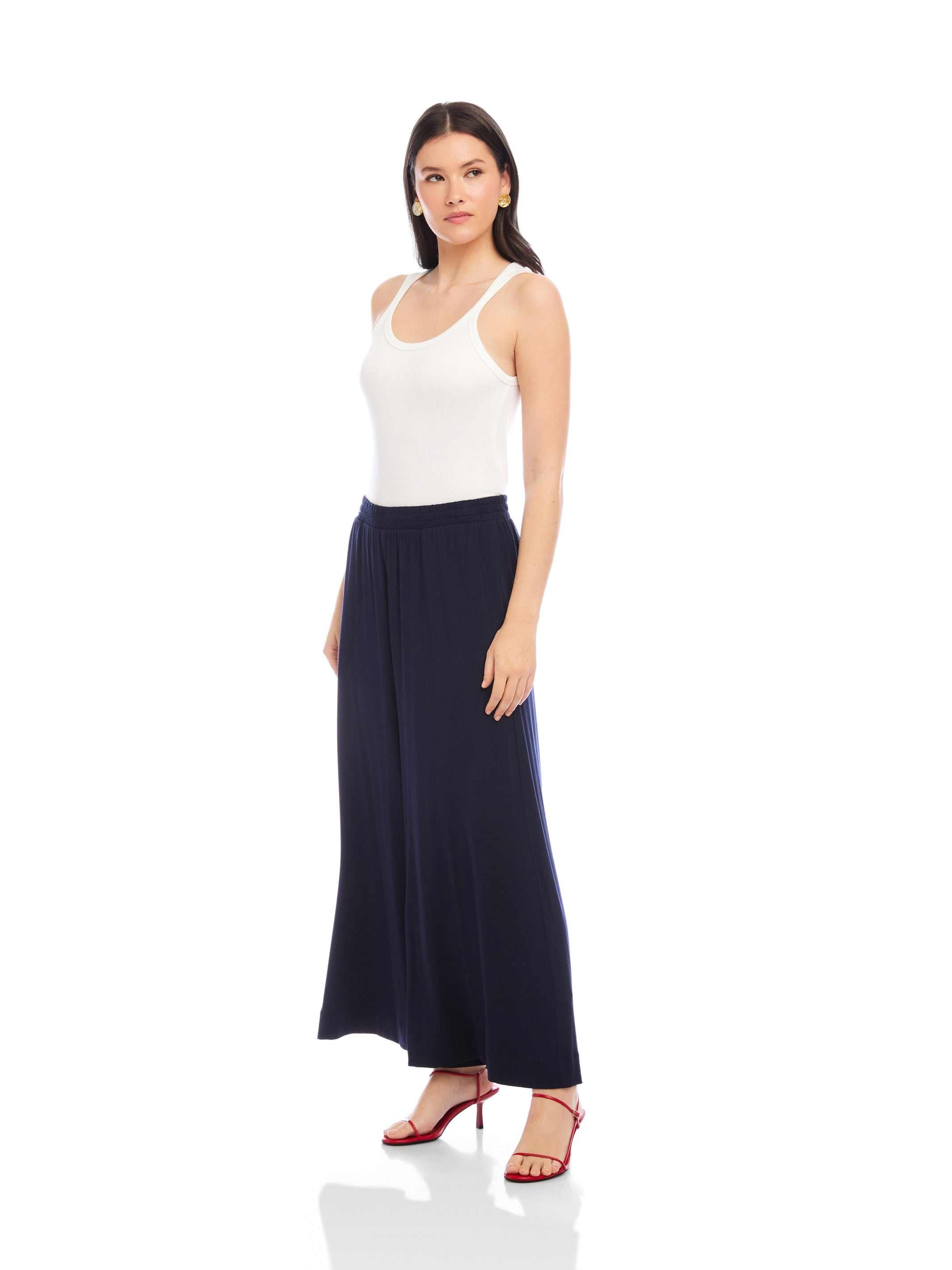 Woman wearing navy Shilo Wide-Leg Ankle Pants with elastic waistband and white tank top
