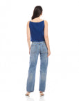 Woman wearing a navy Elis sleeveless button-up top with a boxy fit and light blue jeans, shown from the back