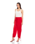 Woman wearing red ankle-length Charo Cargo Pants with drawstring hems and front pockets