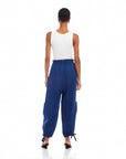 Woman wearing navy blue Charo Cargo Pants with ankle drawstrings and front and side cargo pockets viewed from the back