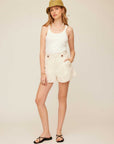 Woman wearing Cassidy Pleated Shorts with front pleats, side pockets, and A-line silhouette in light fabric.