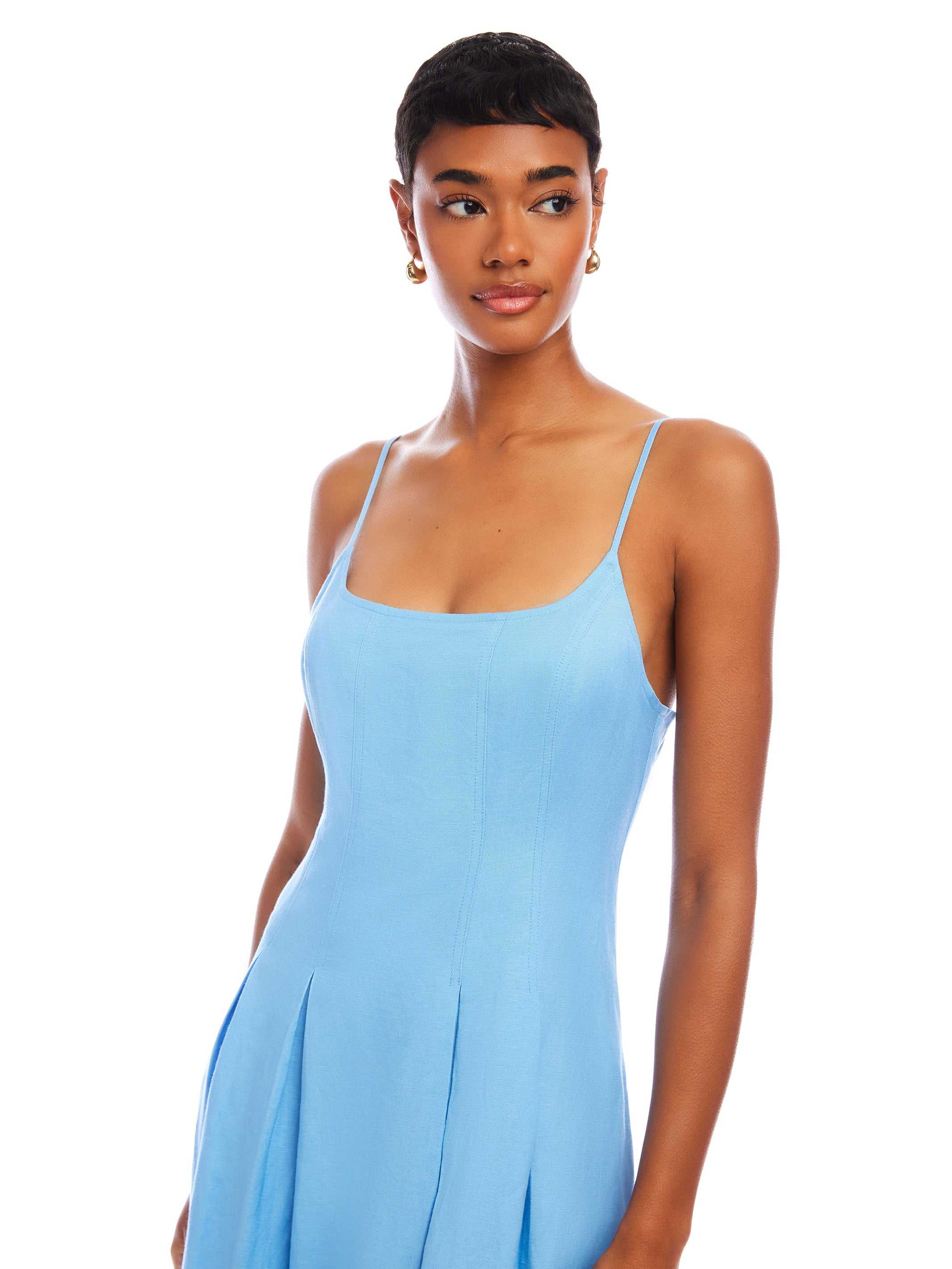 woman wearing sleeveless light blue Jessa Midi Dress with adjustable straps and scoop neck