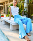 Woman wearing light blue Jana Wide Leg Pants sitting outdoors by a pool
