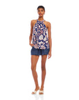 Sicilie Tank in navy viscose crepe with a bold red and cream floral print, sleeveless halter neckline and gathered tie detail.
