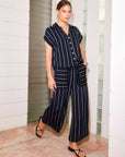 Amanda Cropped Pants with off-white menswear stripes, high-rise wide-leg design, and elastic waistband