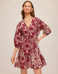 Cream Tasha Tiered Dress with red floral patch print, V-neck, button front, drawstring waist, puffed sleeves, and tiered skirt