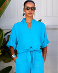 Janice Cuffed Sleeve Tie-Front Top in bright blue linen-rayon blend with cuffed short sleeves, V-neck, and front tie detail.