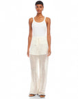 Woman wearing white Gianna crochet pants with drawstring waist and wide leg design