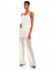 Woman wearing white Gianna crochet pants with drawstring waist and wide leg design