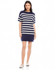 Woman wearing navy and white striped Georgette Sweater Dress with short sleeves and crew neck