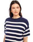 Woman wearing a navy and white striped Georgette Sweater Dress with short sleeves and crew neck