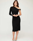Woman wearing elegant Nadia Dress with asymmetric neck and back slit in autumn setting