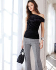 Nadia Top in black crushed velvet with a one-shoulder neckline and twisted off-shoulder detail.