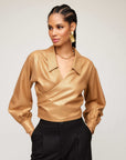 Gold foil print Sloane Wrap Shirt with bishop sleeves and crossover V-neck collar worn with black pants