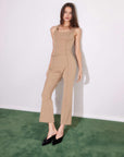 Woman wearing beige Sigourney Saddle Stitch pants with flare leg and front stitch detail