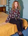 Scarlet tie-front top with maroon and black floral print, V-neck, and long elastic blouson sleeves