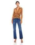 Woman wearing Arabella Shirred Top in soft woven cupro with collared V-neck and cuffed long sleeves