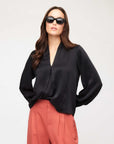 Kiera Blouson Sleeve Top in black with V-neck and long elasticized cuffs, styled with loose sleeves and a relaxed fit
