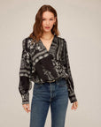 Ines Drape Front Top with monotone paisley print, cross neckline, gathered shoulders, elastic waist, and buttoned cuffs