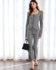Woman wearing Sigourney Pintuck Pants in houndstooth stretch woven fabric with a fitted, cropped, flared silhouette and pintuck details.