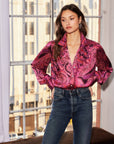 Woman wearing a paisley crinkle satin Chloe Blouse with gathered shoulders and button-down front in a relaxed fit
