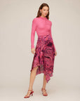 Woman wearing a pink Ceylon Ruffle Skirt with paisley crinkle satin print and asymmetrical ruffle detail.