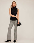 Slim fit black Abbey Turtleneck Tank sleeveless knit top with soft fold-over detail, styled with plaid pants and black heels