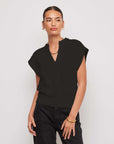 Morgan V-Neck Top in black knit fabric with short cap sleeves, split neckline, and wide band hem for structured fit.