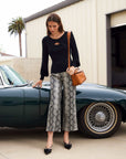 Faux leather cropped pants with snake print and wide-leg fit above ankle