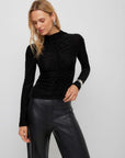 Velvet Burnout Ruched Selena Top in black textured velvet with a subtle houndstooth pattern, mock neck, long sleeves, and front ruching.