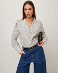 Lizzy Stripe Long Sleeve blouse in cream with navy vertical stripes, ruffle V-neck, gathered shoulders, and button cuffs.