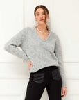 Cozy V-neck sweater with relaxed long sleeves made from a recycled polyester blend