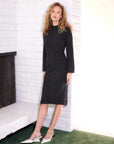 Stylish sweater dress with flared sleeves, mock neck, and back slit made from stretch material for colder weather