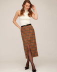Woman wearing sleeveless fitted Kelli Turtleneck Sweater with plaid midi skirt and black heels
