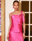 Pink Sasha Tank satin top with asymmetrical bow sleeve and adjustable straps worn by female model