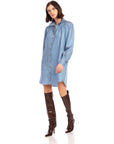 Woman wearing blue Natalia Shirtdress with long sleeves and button front paired with brown thigh-high boots