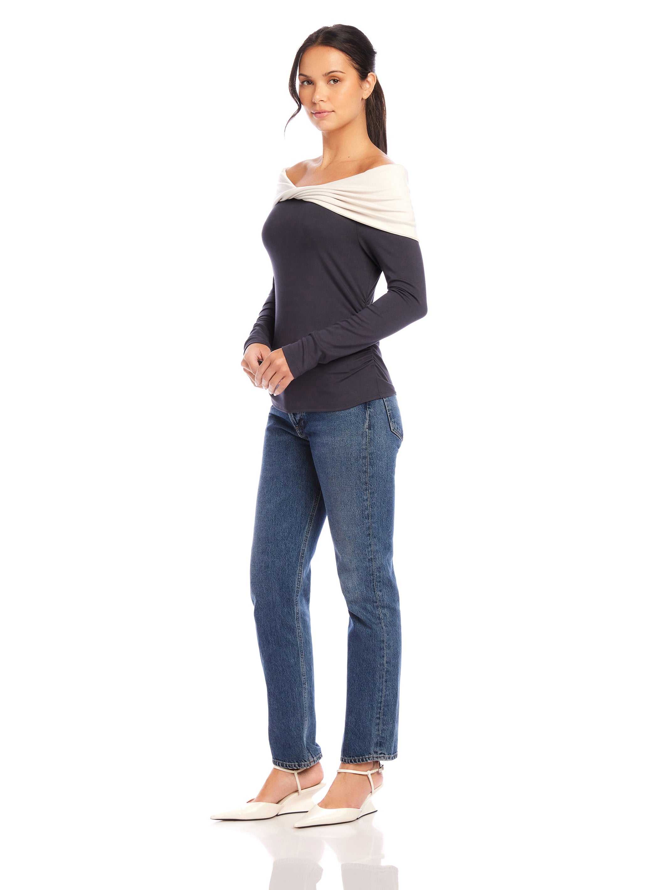 Woman wearing Jillian Off-The-Shoulder Top with twist neck and side shirring paired with jeans and white shoes