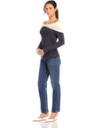 Woman wearing Jillian Off-The-Shoulder Top with twist neck and side shirring paired with jeans and white shoes