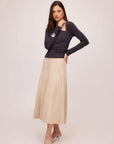 Woman wearing a beige Blythe Faux Suede Midi Skirt with a dark long-sleeve top and heels