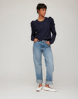 Woman wearing navy Leila Puff Sleeve Top with puff sleeves and crew neck paired with cuffed jeans and white flats